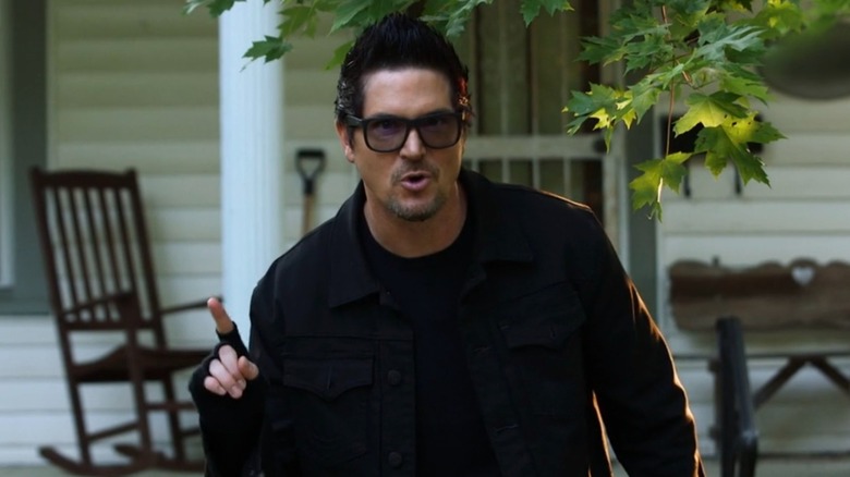 Zak Bagans standing outside house