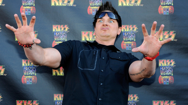 Zak Bagans raising his arms forward