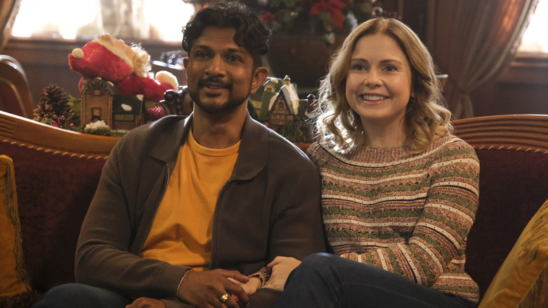 Jay and Samantha sitting on a couch and smiling