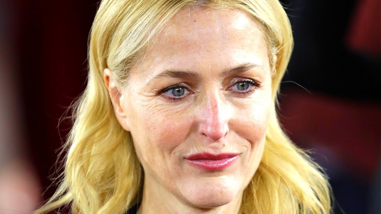 Gillian Anderson smiling and looking down
