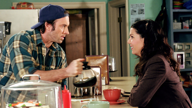 Luke serving Lorelai coffee at the diner counter