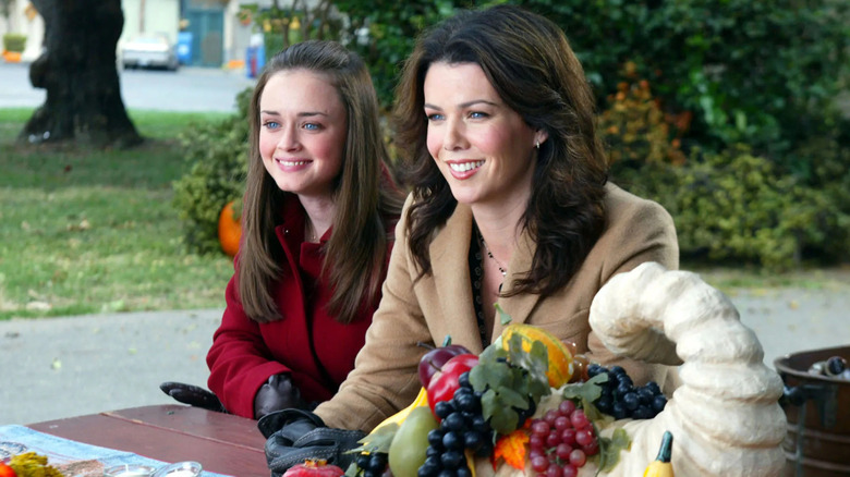 Rory and Lorelai sitting at table smiling