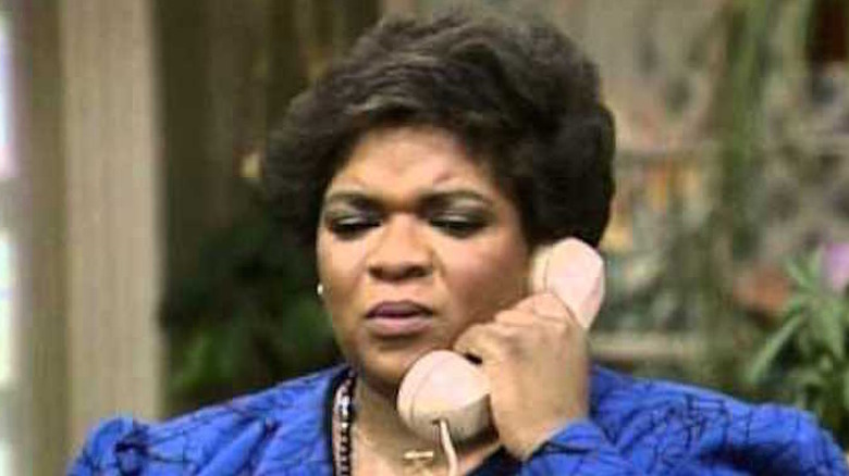 Nell Carter holds a telephone receiver to her ear