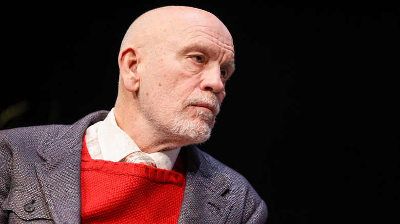 John Malkovich in red sweater