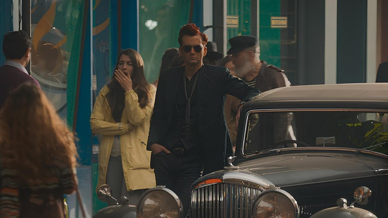 Crowley leaning on his Bentley