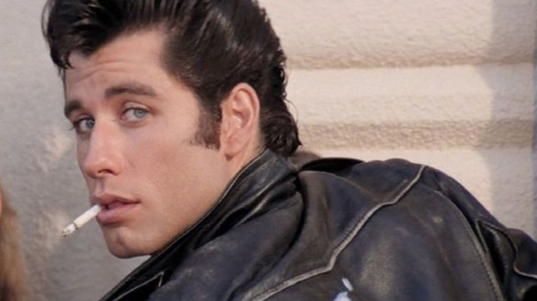 Danny looking over his shoulder smoking