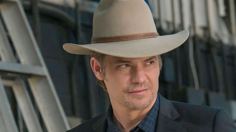 timothy olyphant smirking in a hat