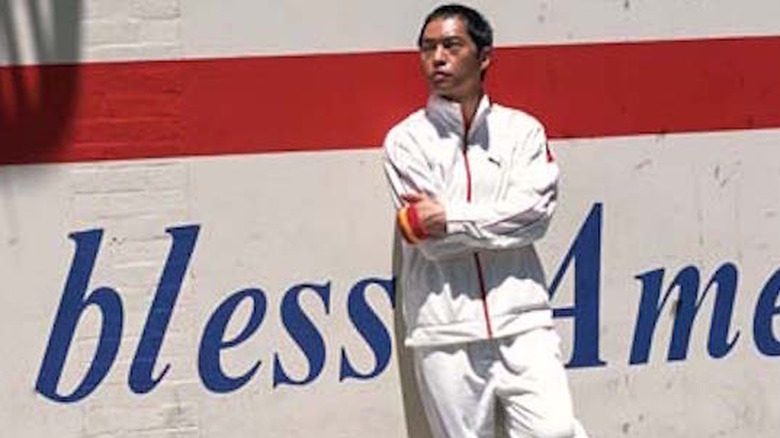 Ken Leung leans on a wall