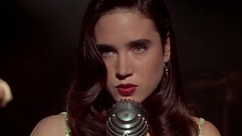 Emma sings into a microphone