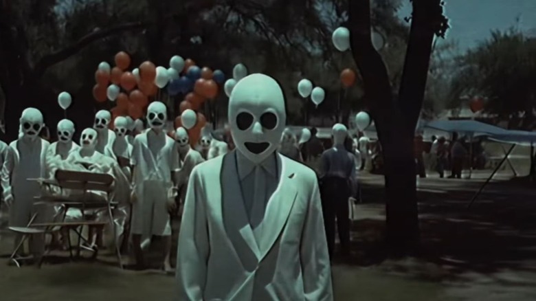 Masked children dressed in white