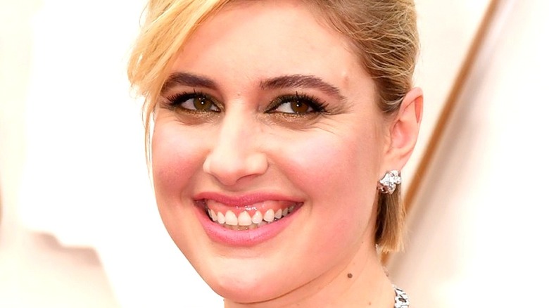 Greta Gerwig smiles on Oscars red carpet 