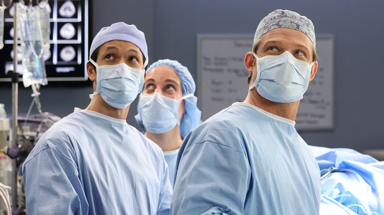 Blue and Link wear surgical gear in the operating room