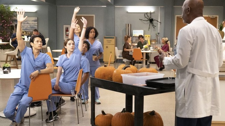 Harry Shum Jr and interns raise hands