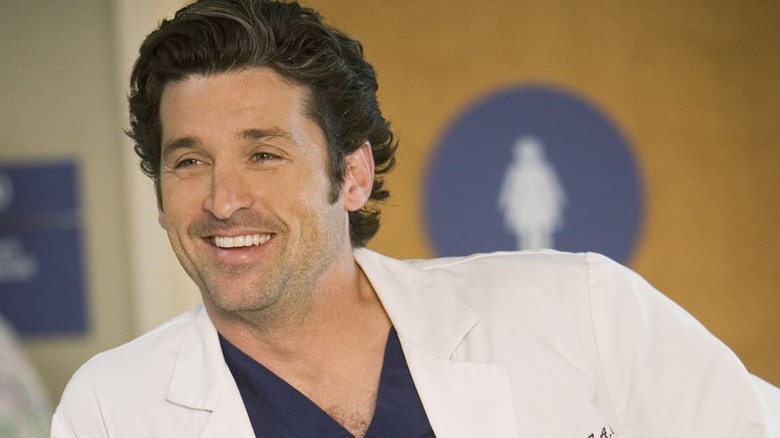 Grey's Anatomy's Derek smiling near counter