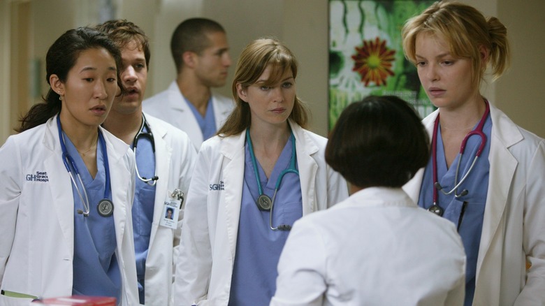 Cristina, George, Meredith, and Izzie listening