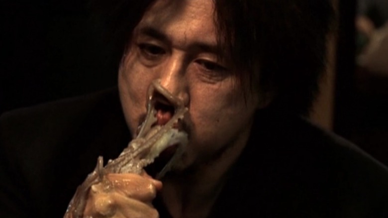 Oh Dae-su eats an octopus in "Oldboy" (2003)