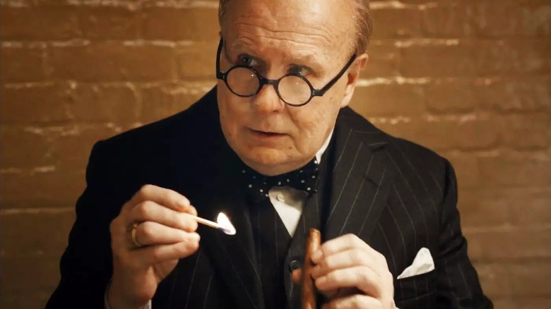 Churchill lights a cigar in "Darkest Hour" (2017)