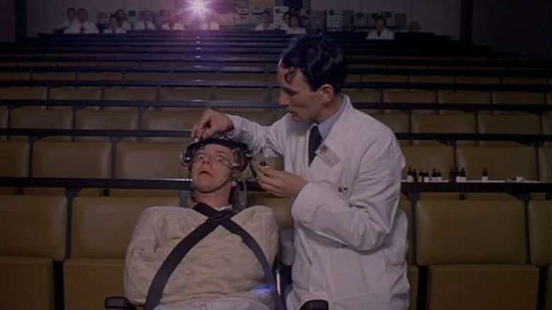 The doctor forces Alex's eyes open in a theater in "A Clockwork Orange" (1971)