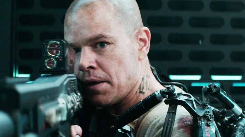 Max DeCosta aims a weapon in "Elysium" (2013)