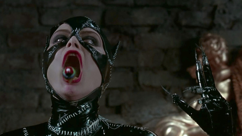 Catwoman lets a bird fly free from her mouth in "Batman Returns" (1992)