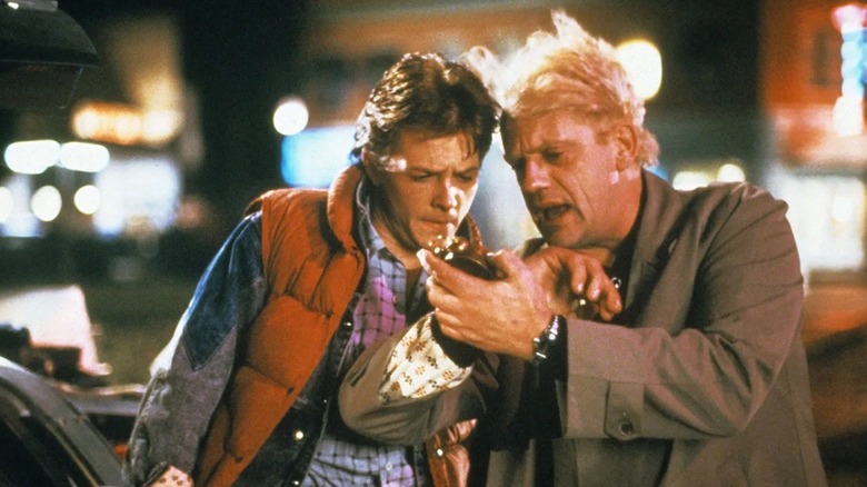 Marty McFly and Doc Brown checking the time in Back to the Future (1985)