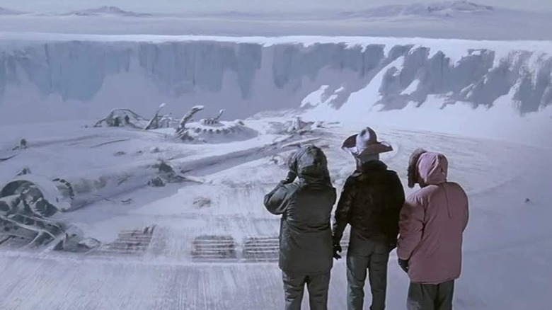 A trio of characters encountering a destroyed lab in The Thing (1982)
