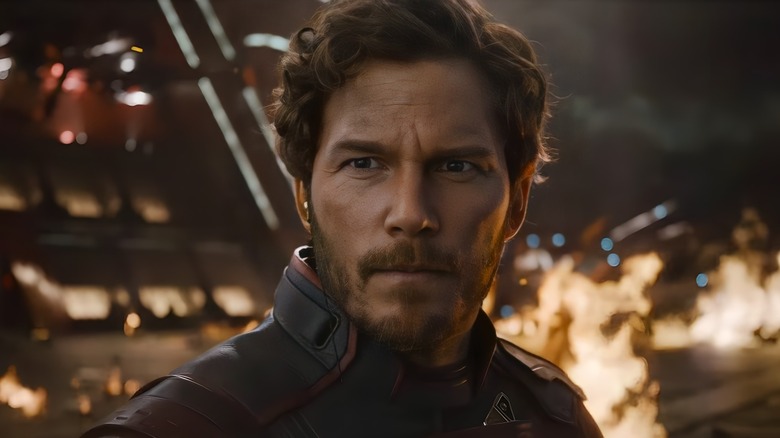 Star-Lord standing ahead of fire