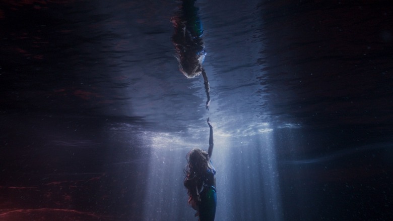 Ariel touching her reflection in the water