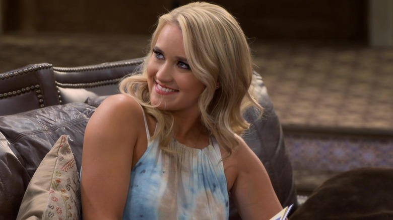 Gabi sitting on a couch smiling in Young & Hungry (2014)