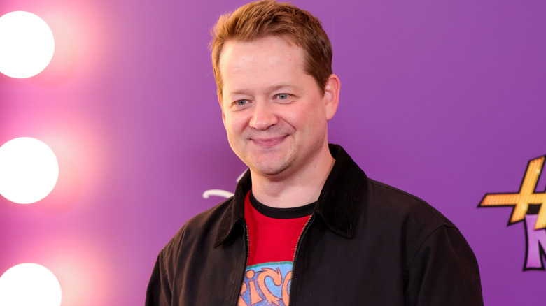 Jason Earles smiling at the premiere of Hannah Montana: 20th Anniversary Special