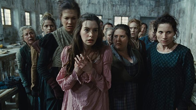 Fantine stands with factory women
