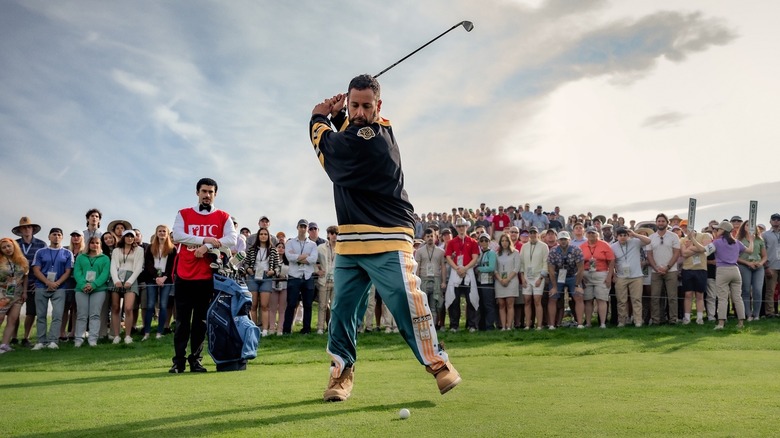 Happy winding up for a shot with his caddy, Oscar in the background (2025)