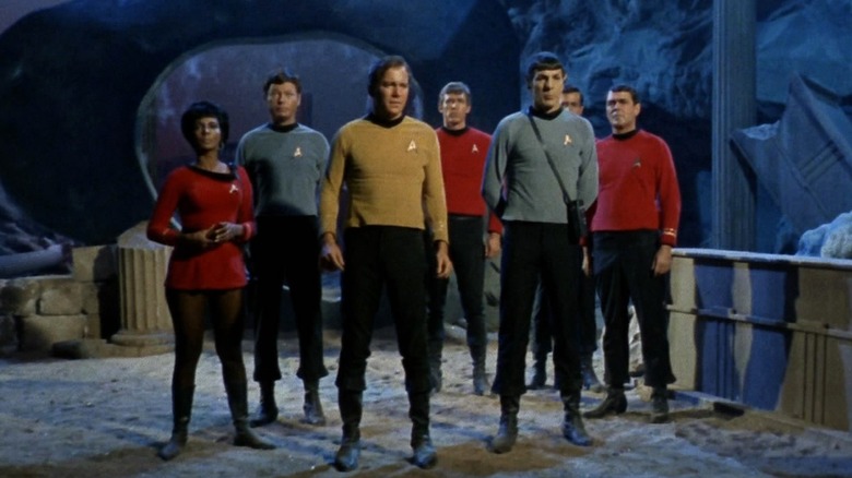 Captain James T. Kirk and his crew standing together in Star Trek