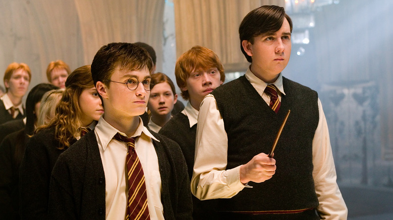 Neville holding wand