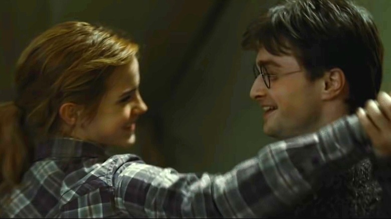 Harry and Hermione smiling and dancing