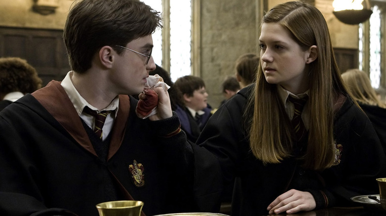Ginny Weasley sitting in Great Hall with Harry Potter