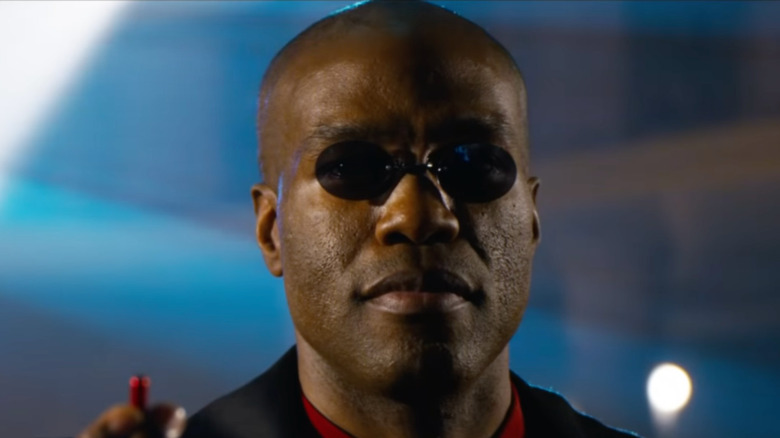 Morpheus holding red pill The Matrix Resurrections