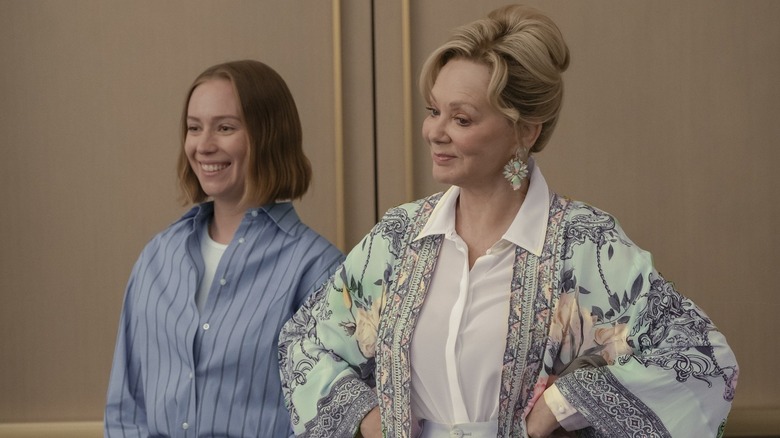 Ava and Deborah smiling at a room full of people on Hacks