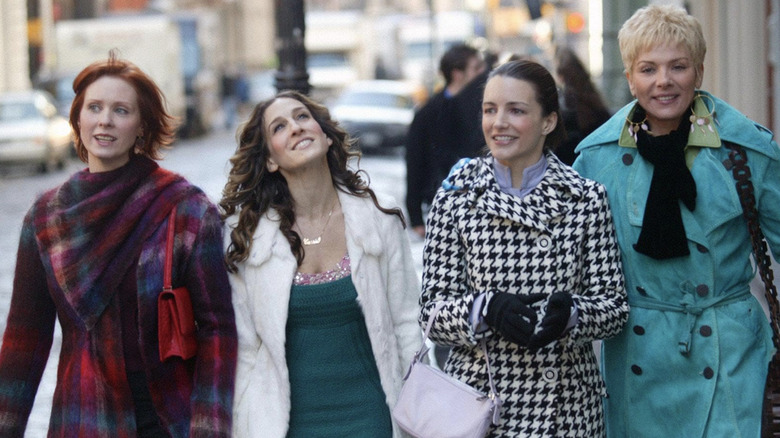 Miranda, Carrie, Charlotte, and Samantha walking down the street together in "Sex and the City"