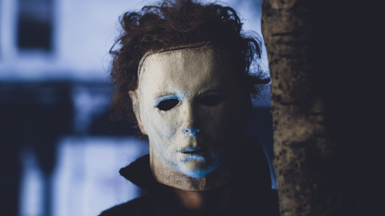 Michael Myers lurking behind a tree