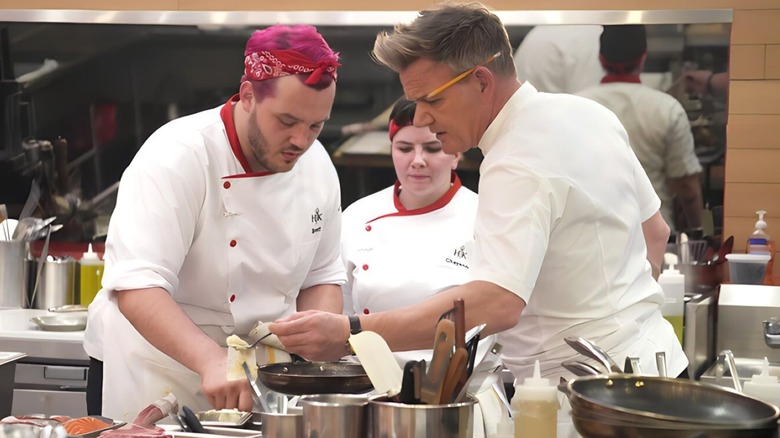 Brett Binninger-Schwartz, Cheyenne Nichols, and Gordon Ramsay stand in Hell's Kitchen