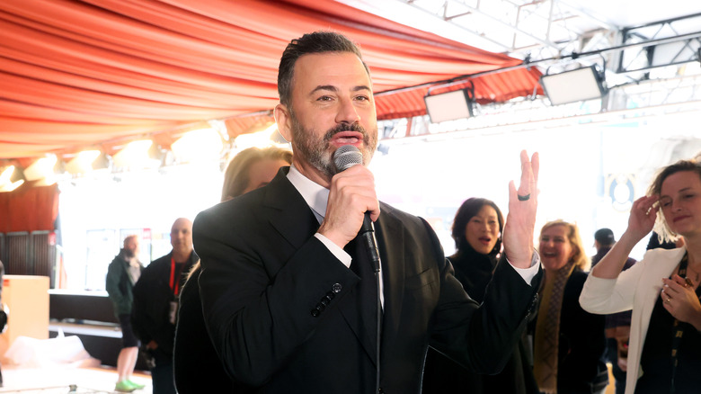 Jimmy Kimmel holding a microphone
