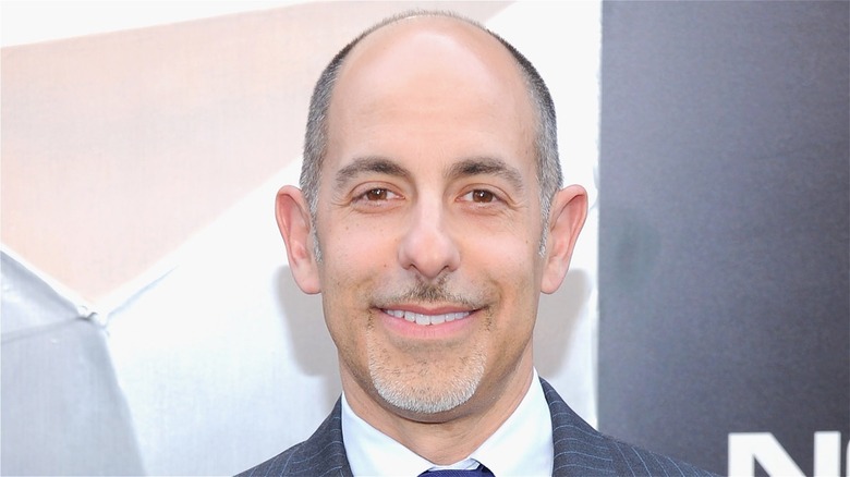 David S. Goyer smiling, wearing suit