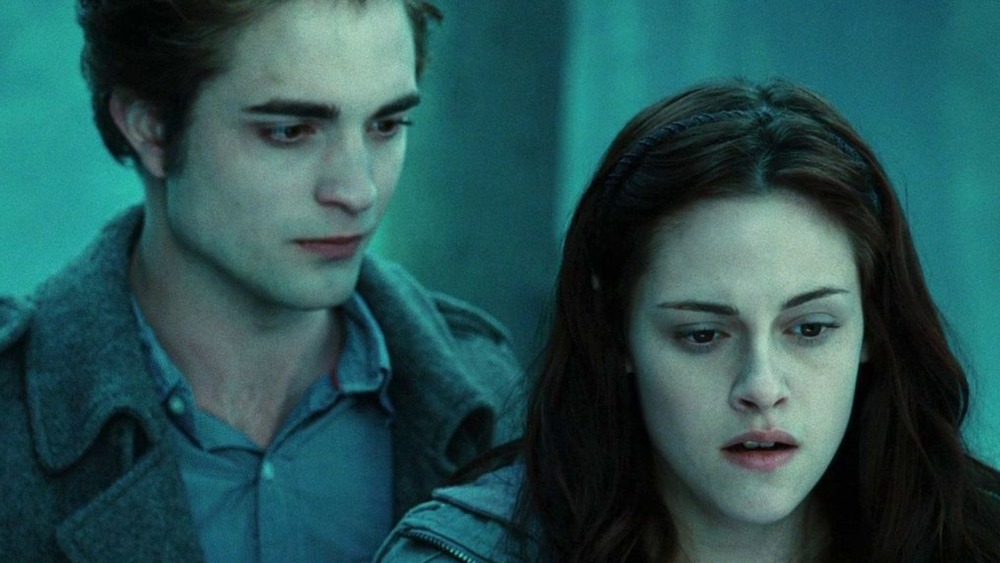 Edward and Bella stand in forest in Twilight