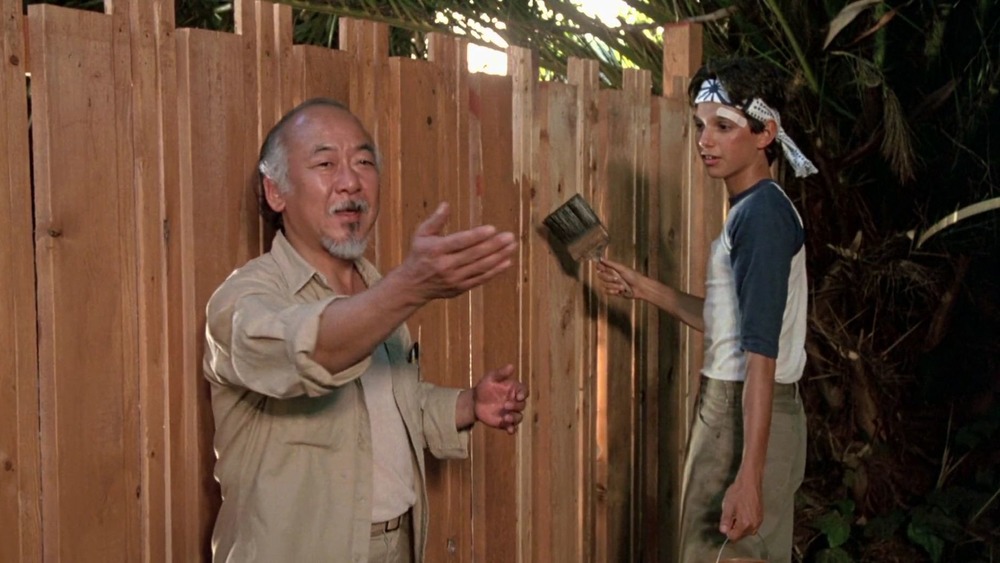 Mr. Miyagi and Daniel paint a fence in The Karate Kid