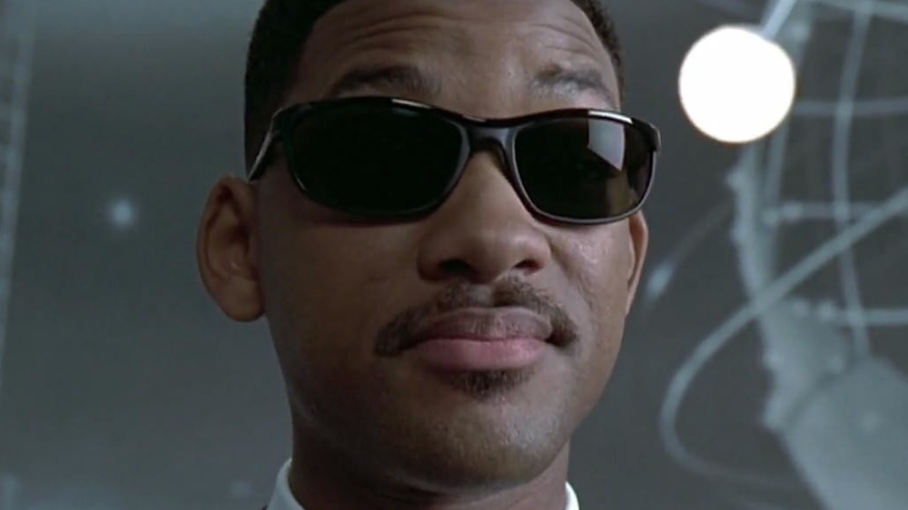 Will Smith wearing sunglasses and smirking in Men in Black