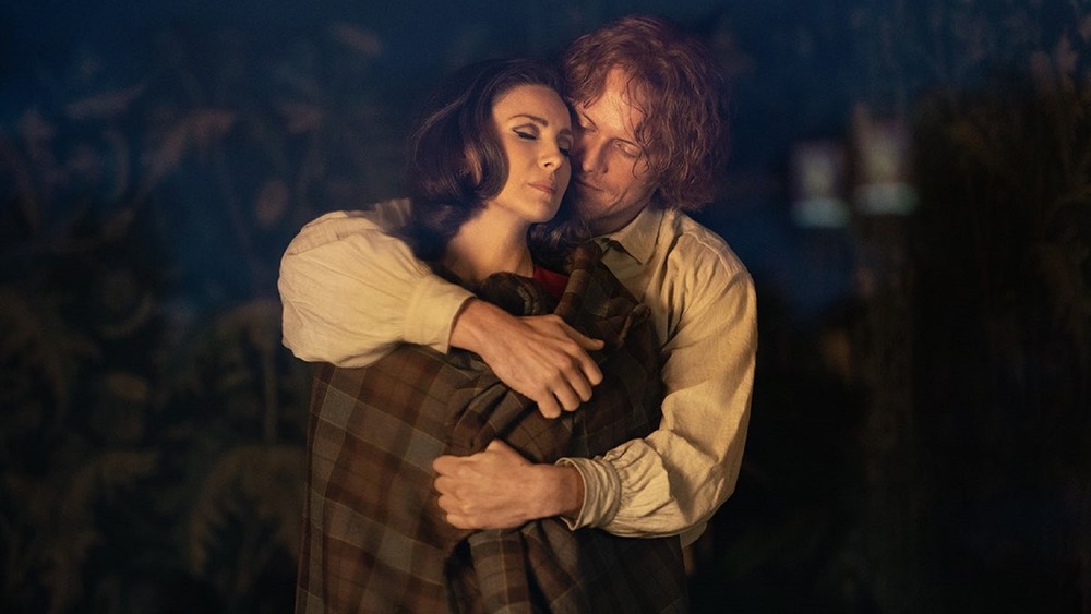 Jamie Fraser (Sam Heughan) holds Claire Randall (Caitriona Balfe) on Outlander