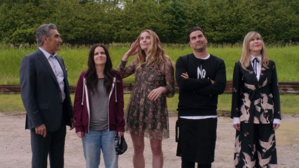 The Rose family admires their hotel on Schitt's Creek