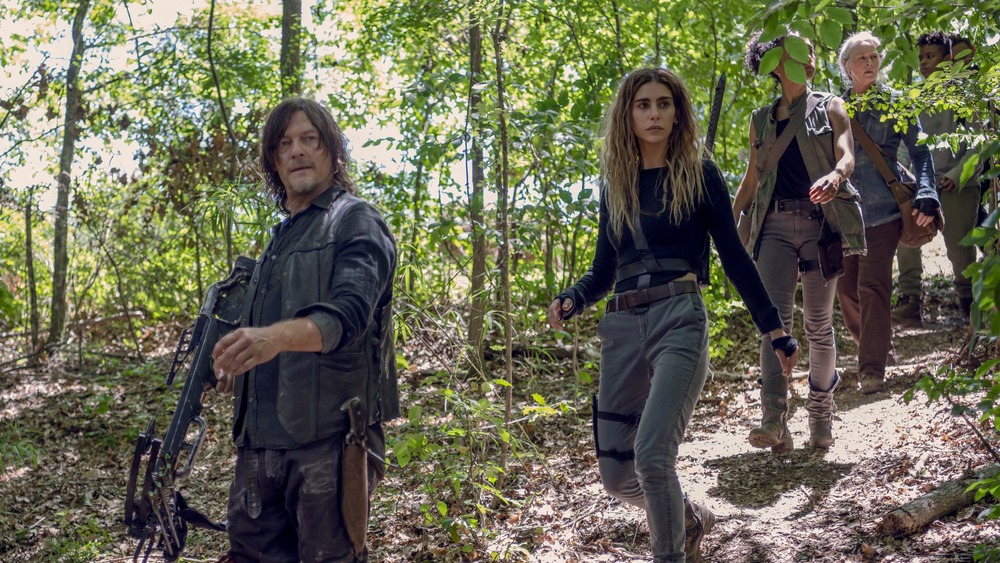 Daryl (Norman Reedus) leads a group through the woods on The Walking Dead