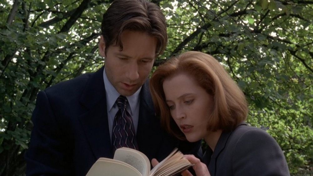 Mulder and Scully examine a book